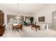 Open-concept living area featuring a dining table, formal living, and large windows showcasing backyard views at 462 N Bedford Ct, Chandler, AZ 85225