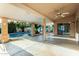 Spacious covered patio with ceiling fan overlooking pool and desert landscape at 462 N Bedford Ct, Chandler, AZ 85225