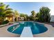 A diving board sits over an in-ground pool surrounded by desert landscaping, including cactus and palm trees at 462 N Bedford Ct, Chandler, AZ 85225