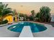 Beautiful backyard pool with diving board and lush desert landscaping at sunset at 462 N Bedford Ct, Chandler, AZ 85225