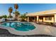Inviting backyard pool and spa with surrounding rock landscaping and a covered patio attached to the home at 462 N Bedford Ct, Chandler, AZ 85225