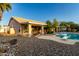 Back of house with outdoor pool and diving board surrounded by gravel and foliage at 462 N Bedford Ct, Chandler, AZ 85225