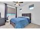 Well-lit bedroom with blue bedspread, dark wooden furniture, ceiling fan, and a great view at 550 E Zion Pl, Chandler, AZ 85249