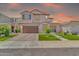 Charming two-story home with a well-manicured lawn and a warm sunset backdrop at 550 E Zion Pl, Chandler, AZ 85249