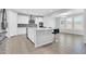 Modern kitchen features stainless steel appliances, white cabinets, and a center island with bar stools at 550 E Zion Pl, Chandler, AZ 85249