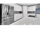 Modern kitchen boasts stainless steel refrigerator and sink with quartz countertops and backsplash at 550 E Zion Pl, Chandler, AZ 85249