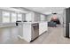 Bright kitchen features stainless steel appliances, a white island, and an adjacent living space at 550 E Zion Pl, Chandler, AZ 85249