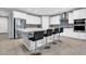 Bright kitchen features white cabinets, stainless appliances, and a large center island with bar seating at 550 E Zion Pl, Chandler, AZ 85249