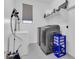 Organized laundry room equipped with modern washer and dryer, shelving, and additional storage space at 550 E Zion Pl, Chandler, AZ 85249