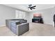 Cozy living room with a comfortable couch, a ceiling fan, and a mounted TV for relaxation at 550 E Zion Pl, Chandler, AZ 85249