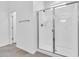Modern bathroom featuring glass shower door, white walls, and tile floors, with a view of the doorway at 550 E Zion Pl, Chandler, AZ 85249