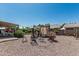Spacious gravel backyard featuring a shaded pergola and various seating arrangements at 6247 E Albany St, Mesa, AZ 85205