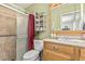 Cozy bathroom featuring a shower, vanity, and a decorative shelf with charming accents at 6247 E Albany St, Mesa, AZ 85205