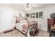 Charming bedroom featuring a vintage bed, natural light, and a decorative rocking horse accent at 6247 E Albany St, Mesa, AZ 85205