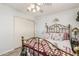 Bright bedroom featuring vintage bed, natural light, and hardwood floors at 6247 E Albany St, Mesa, AZ 85205