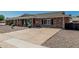 Charming single-story brick home featuring desert landscaping with a concrete driveway at 6247 E Albany St, Mesa, AZ 85205