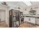 Kitchen features updated appliances, white cabinetry, subway tile backsplash, and tile floors at 6247 E Albany St, Mesa, AZ 85205