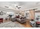 Comfortable living room with natural light, hardwood floors, sliding barn doors, and ceiling fan at 6247 E Albany St, Mesa, AZ 85205