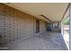 Covered back patio offers tile floors, brick details, and a peaceful outdoor living space at 6449 E Ellis St, Mesa, AZ 85205