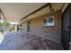 Covered back patio features colorful tile flooring, brick accents, and views of the backyard at 6449 E Ellis St, Mesa, AZ 85205