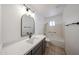 Bright bathroom features a modern vanity with a white countertop and black faucet and trim at 6449 E Ellis St, Mesa, AZ 85205