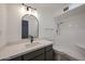 Bright bathroom features a stand-up shower and a modern vanity with a white countertop and black faucet and trim at 6449 E Ellis St, Mesa, AZ 85205