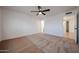 Large bedroom with a ceiling fan and neutral carpet at 6449 E Ellis St, Mesa, AZ 85205