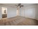 Bright bedroom with a ceiling fan, carpet, and closet at 6449 E Ellis St, Mesa, AZ 85205