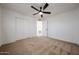 Comfortable bedroom featuring neutral carpet, a ceiling fan, and double door closet at 6449 E Ellis St, Mesa, AZ 85205