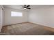 Spacious bedroom with a ceiling fan and plush carpet flooring at 6449 E Ellis St, Mesa, AZ 85205