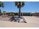 Attractive single-level residence with palm trees, desert rock landscaping, and a convenient attached garage at 6449 E Ellis St, Mesa, AZ 85205