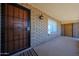 Inviting covered front porch features a security door, brick accents, and a classic exterior light fixture at 6449 E Ellis St, Mesa, AZ 85205
