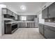 Spacious kitchen featuring tile floors, gray cabinetry, stainless steel appliances, and ample counter space at 6449 E Ellis St, Mesa, AZ 85205