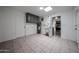 Well-lit utility room boasts tile floors, storage cabinets, a utility sink, and easy access to the kitchen at 6449 E Ellis St, Mesa, AZ 85205