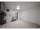 Bright utility room featuring tile flooring, a skylight, and convenient access doors at 6449 E Ellis St, Mesa, AZ 85205