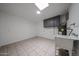 Utility room with tile floors, a utility sink, and a skylight for natural light at 6449 E Ellis St, Mesa, AZ 85205