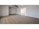 Spacious living room with a ceiling fan, neutral carpet, and an open layout leading to other areas of the home at 6449 E Ellis St, Mesa, AZ 85205