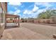 Large backyard with desert landscaping, covered patio, and block wall at 7207 W Alta Vista Rd, Laveen, AZ 85339