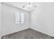Bedroom featuring tile floors, a ceiling fan, and a large window at 7207 W Alta Vista Rd, Laveen, AZ 85339