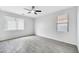 A bright bedroom features large windows for ample light and modern ceiling fan and neutral finishes at 7207 W Alta Vista Rd, Laveen, AZ 85339