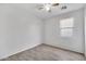 Clean bedroom with tile floors, window with blinds, and a modern ceiling fan at 7207 W Alta Vista Rd, Laveen, AZ 85339