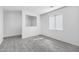 Serene bedroom with neutral walls, gray wood-look floors, and a bright window at 7207 W Alta Vista Rd, Laveen, AZ 85339