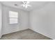 Bright bedroom features tile floors, a ceiling fan, and natural light from the window at 7207 W Alta Vista Rd, Laveen, AZ 85339