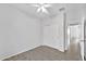 A spacious bedroom with a closet and open doorway, features tile floors and neutral walls at 7207 W Alta Vista Rd, Laveen, AZ 85339