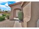 Close-up of the arched front entry with decorative greenery and a welcoming walkway at 7207 W Alta Vista Rd, Laveen, AZ 85339