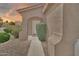 Charming front entrance with an arched entryway and well-maintained landscaping at 7207 W Alta Vista Rd, Laveen, AZ 85339