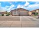 Beautiful home featuring a two-car garage and attractive desert landscaping at 7207 W Alta Vista Rd, Laveen, AZ 85339