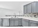 Bright kitchen with stainless steel dishwasher and sink, with bar-height counter to adjacent room at 7207 W Alta Vista Rd, Laveen, AZ 85339