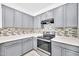 Kitchen features light countertops, stainless steel appliances, and subway tile backsplash at 7207 W Alta Vista Rd, Laveen, AZ 85339
