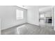 Bright living room with gray wood-look flooring and large windows providing natural light at 7207 W Alta Vista Rd, Laveen, AZ 85339